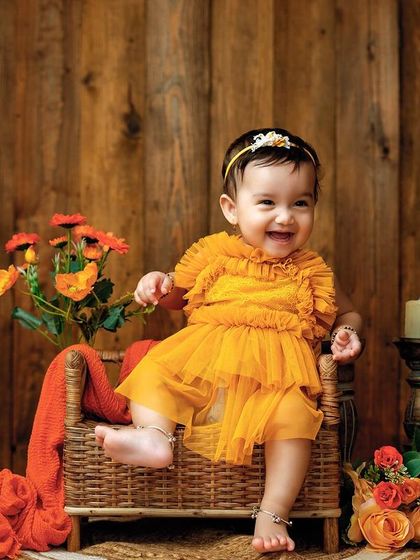 The happiest smile. This sitter session captures the pure delight of a baby who is happy, comfortable, and enjoying the spotlight.