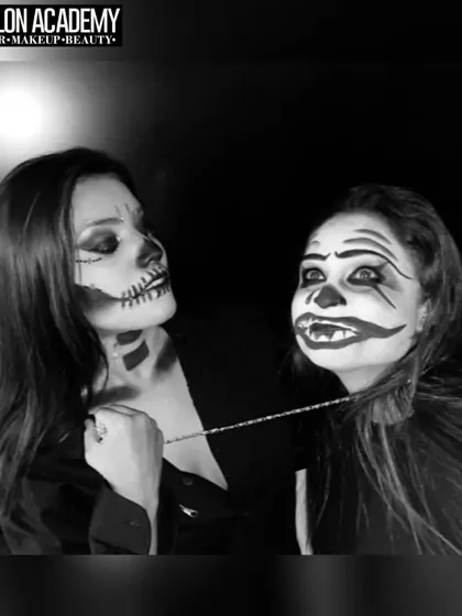 A black and white photo of two students with their finished Halloween makeup. This shows the fun and collaborative environment of our creative workshops.