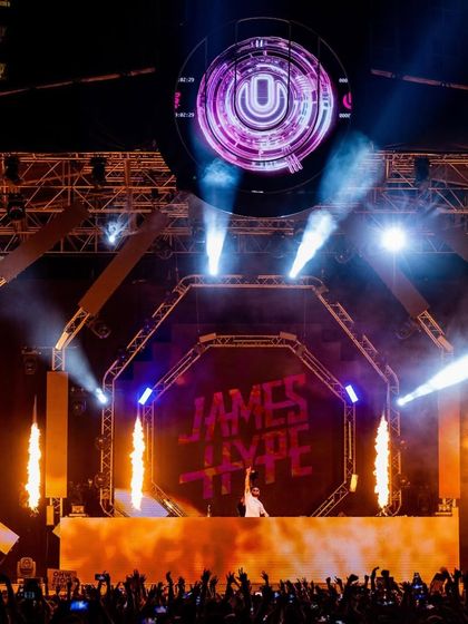 The 'Road To Ultra' stage in all its glory, with James Hype at the center of a massive production featuring fire jets and the iconic 'U' logo.