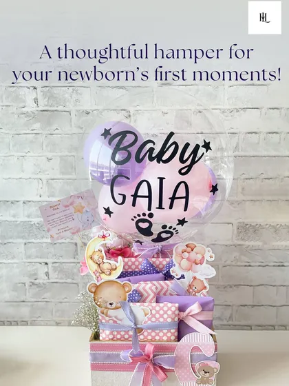 A thoughtful hamper for baby Gaia's first moments. This gift features a personalized balloon, a custom initial, and essentials wrapped in adorable teddy bear prints.