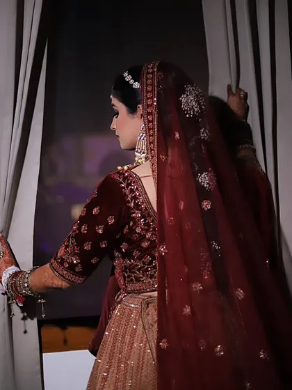 A duplicate of image 129, showing the bride from the back. This pose is great for showing off the details of the blouse and hairstyle.