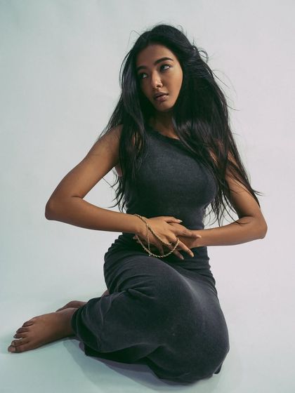 A seated pose that is both elegant and strong, showcasing the model's control and grace.