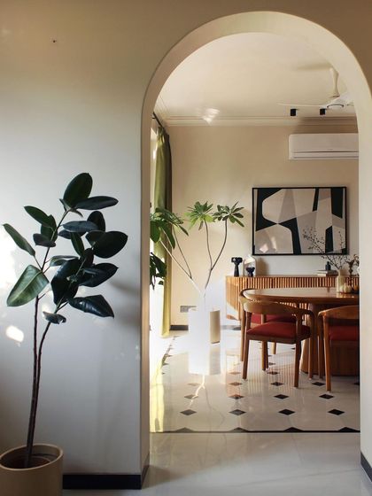 An archway frames the view into the dining room, a technique we used throughout the house to create a sense of discovery. This perspective highlights the home's layered and continuous design.