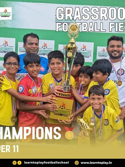 Champions! The Under-11 boys celebrate with their trophy after winning the Grassroots Football Fiesta.