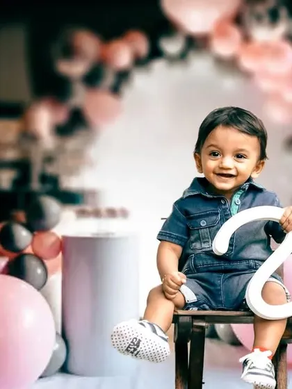 A stylish pre-birthday portrait session. With creative use of props and a vibrant balloon backdrop, we can create modern and fun images that celebrate your child's unique charm.