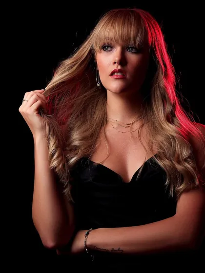 A more serious expression from the same setup, showing how a simple change in expression can alter the mood of a red-lit portrait.