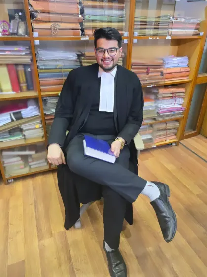 In my chamber, surrounded by law books. I believe fearlessness is the most essential quality for an advocate, allowing me to represent my client's case with courage and conviction before the court.