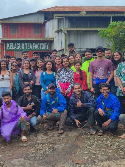 A group photo in front of the Kelagur Tea Factory, a stop on our Bandaje trek itinerary.