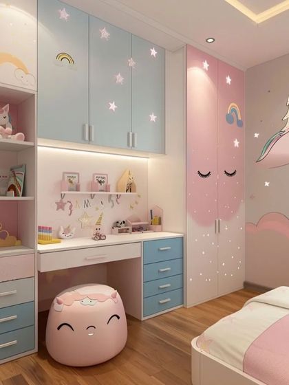 This unicorn-themed bedroom combines soft pink and blue tones. The custom furniture includes a study desk with drawers, overhead storage, and a wardrobe with whimsical cloud and unicorn decals.