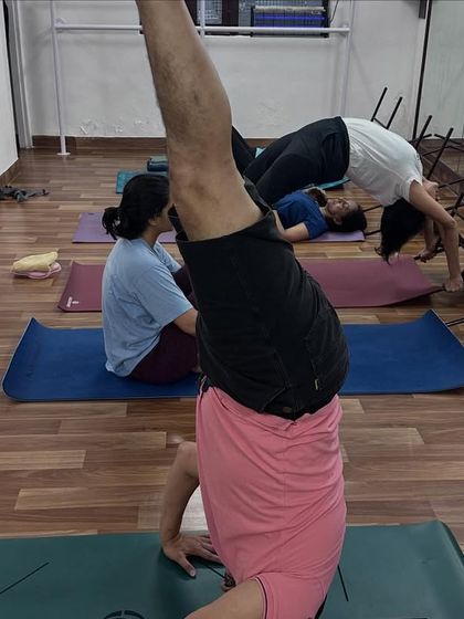 Our studio is a space for all levels of practice to coexist. While one student works on a supported backbend, another practices a variation of Sirsasana (Headstand).