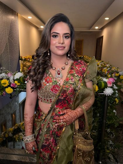 Blossoming with beauty for her Mehendi. I created a soft glam look to complement her floral Gazal Gupta saree, perfect for a garden celebration.