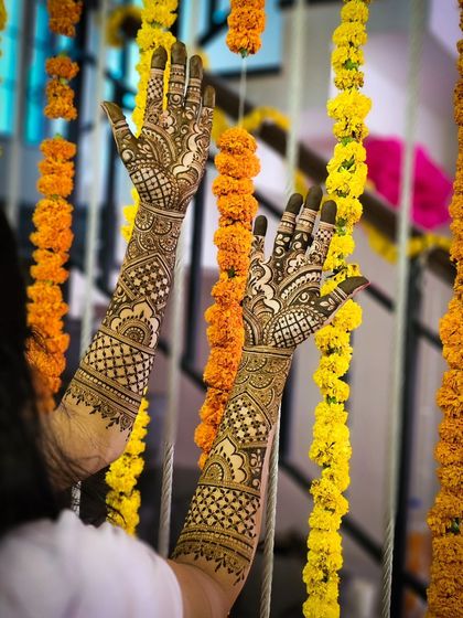 A beautiful shot of bridal henna against a backdrop of marigold flowers.