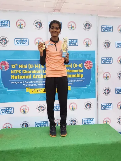 One of our students stands proudly on the podium after winning a team gold medal at the 13th Mini Sub Junior National Archery Championship. This is a huge achievement.