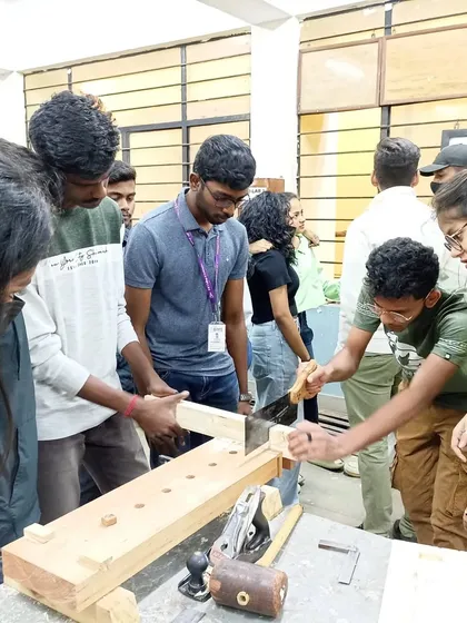 Students getting hands-on experience with a Japanese pull saw, learning how to make a clean and accurate cut.