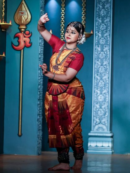 Another moment from my offering to Lord Shiva at Natyanjali. The 'Om' symbol and temple lamps in the background added to the spiritual atmosphere of the performance.