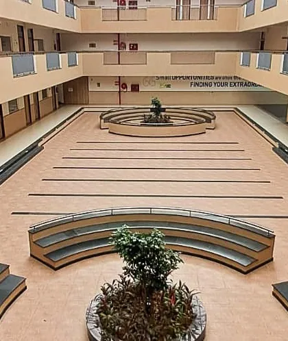 The central atrium of the EuroSchool campus, designed as a multi-functional common area. This expansive, naturally lit space encourages student interaction and hosts school events, featuring tiered seating and open corridors across multiple floors.