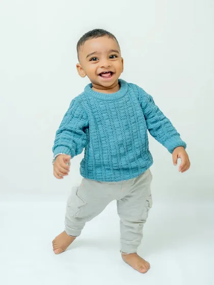 Capturing the energy of a toddler on the move! This simple studio portrait showcases the pure, uninhibited happiness of childhood with a clean background that lets your little one's personality shine.