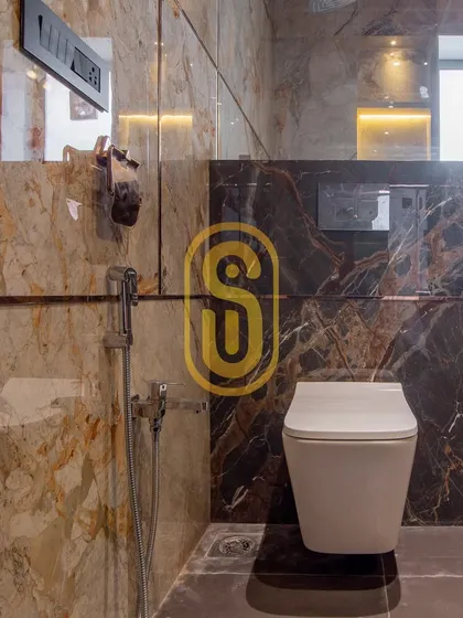 This image highlights the detailed tile work in one of our bathroom projects, combining two different types of marble. We ensure every detail, including the placement of fixtures, is perfectly executed.