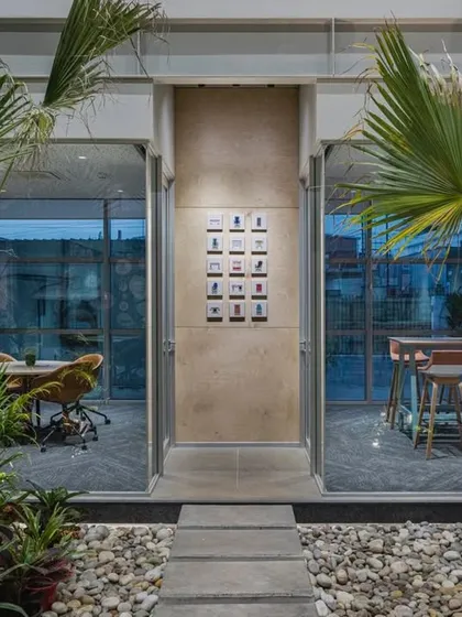 A perfect example of landscape and interiors merging. This meeting space opens directly onto a courtyard filled with pebbles and tropical plants, blurring the line between inside and out.