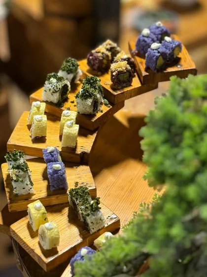 Another angle of our sushi tower, showcasing the different colours and textures of the rolls, from classic white rice to modern purple and black rice versions.
