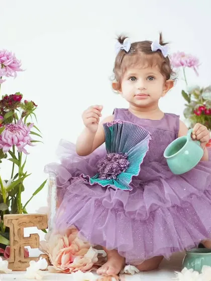 A first birthday portrait with a floral tea party theme. We have a variety of props like this little teapot to make the setup special.