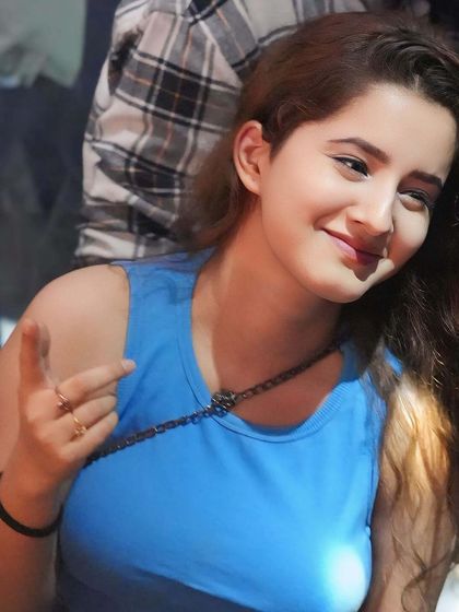 A candid shot of a guest enjoying the party. The red lighting creates a warm and energetic ambiance.