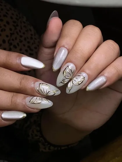 A pearly white base with delicate gold butterfly line art. This design is ethereal and elegant.