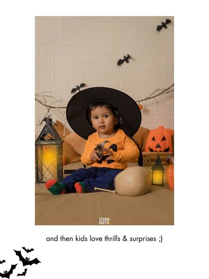 A baby tries on a big witch hat during our fun Halloween mini-session.