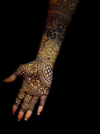 A close-up of the intricate floral and jaali patterns from the same design, showcasing the deep, consistent color achieved with my natural henna.
