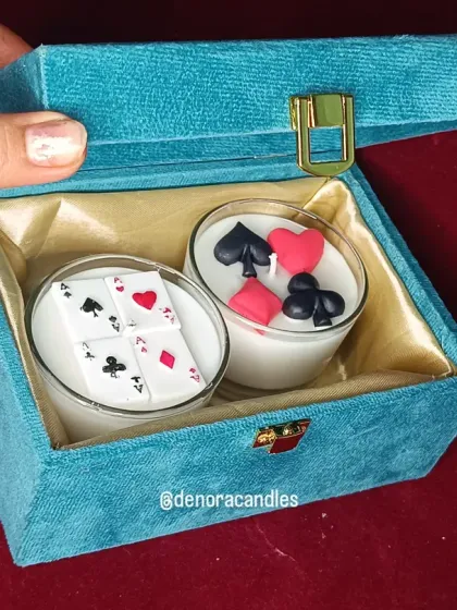 A top-down view of the poker candle gift set inside its luxurious packaging.