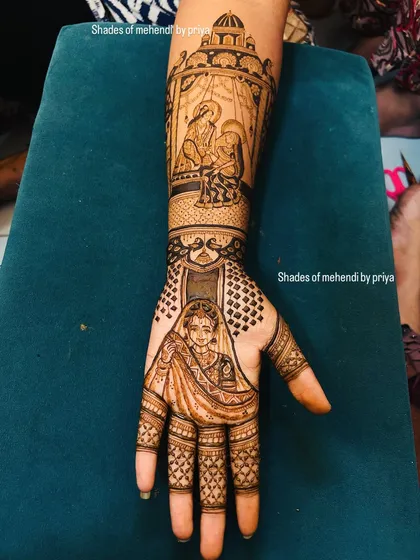 A unique bridal mehendi telling a story across the hand and arm. The palm features a bride's portrait, while the arm depicts a beautiful baby shower (godh bharai) ceremony scene.