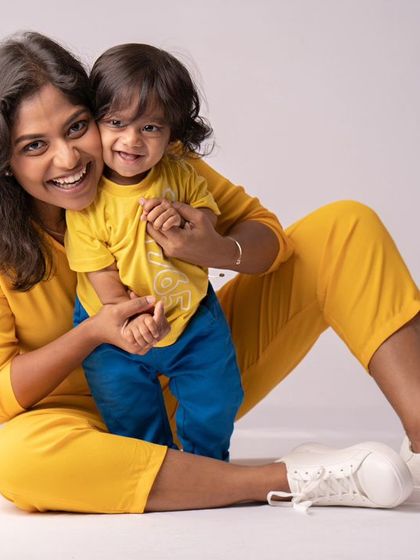 A mother and son, sitting together and sharing a happy moment.