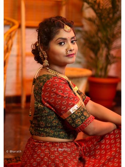 A seated portrait in a warm, inviting indoor setting, perfect for capturing the essence of traditional style.