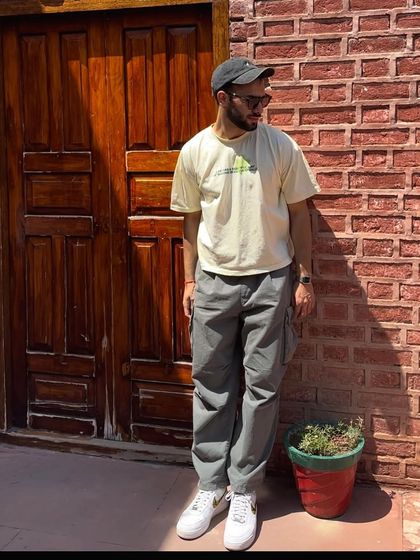 A client styling the leopard swoosh custom sneakers with cargo pants.