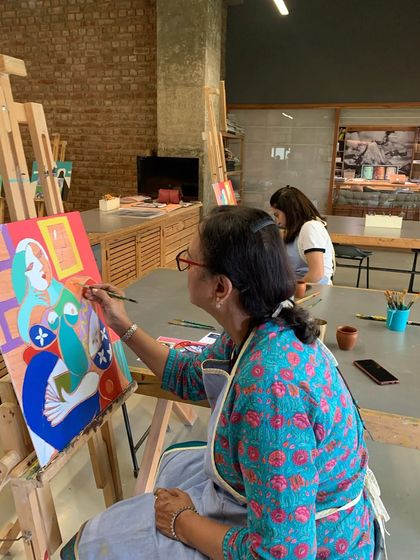 An adult student enjoying the process of recreating a Picasso masterpiece, adding her own flair to the iconic portrait.