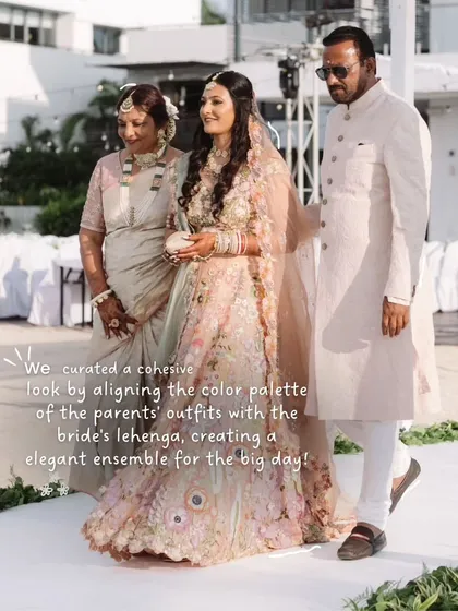 A beautiful family portrait. We curated a cohesive look by aligning the color palette of the parents' outfits with the bride's lehenga, creating an elegant and coordinated ensemble for the big day.
