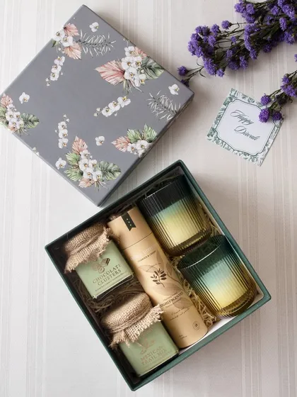 This elegant grey floral box is filled with jars of our chocolate clusters and other gourmet snacks, paired with two beautiful ombre glasses. It's a gift that speaks of sophistication.