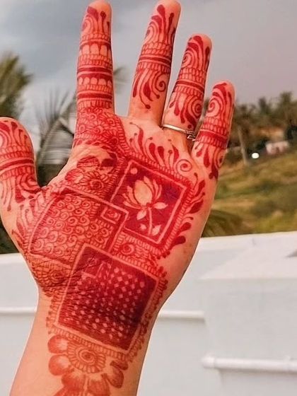 The final stain of a geometric and lotus-inspired design. The vibrant red color stands out beautifully, a testament to the power of natural henna ingredients.