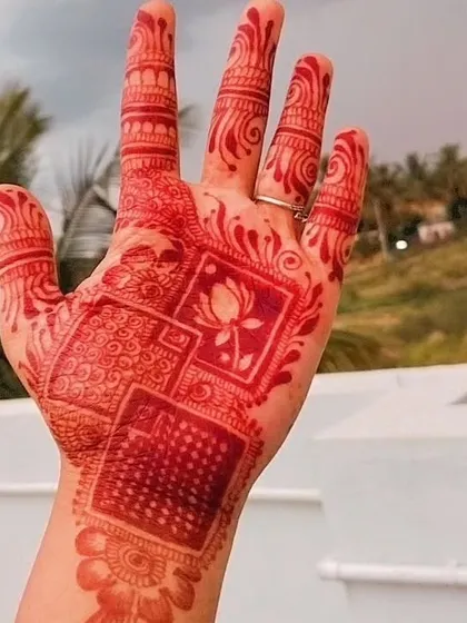 This modern henna design features clean lines, geometric blocks, and a central lotus motif. The bright red stain shows how versatile my henna is for both traditional and contemporary art.
