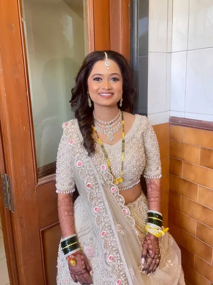 A full portrait of the bride, looking serene and beautiful in her reception attire.