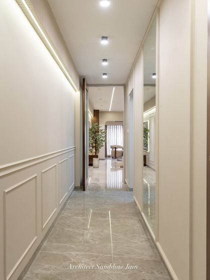 A passage that speaks quiet elegance. Classic wall mouldings, subtle mirrors, and a calming neutral palette come together to create depth, dimension, and timeless charm in this transition space.