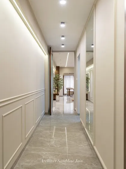 A passage that speaks quiet elegance. Classic wall mouldings, subtle mirrors, and a calming neutral palette come together to create depth, dimension, and timeless charm in this transition space.
