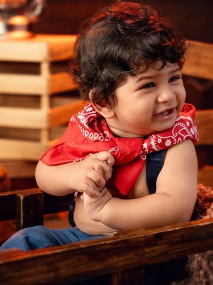 A candid, giggling moment from our cowboy, capturing pure, uninhibited happiness.