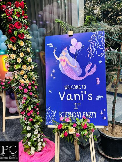 A custom "Welcome to Vani's 1st Birthday Party" sign, designed with mermaid graphics. Placed at the entrance, it's the perfect start to a themed celebration.