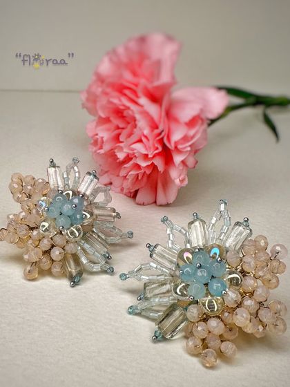 Be a showstopper with these handcrafted fashion studs from the FLORAA collection. The combination of pastel blue and peach beads creates a delicate, starburst effect perfect for Haldi or Mehendi events.