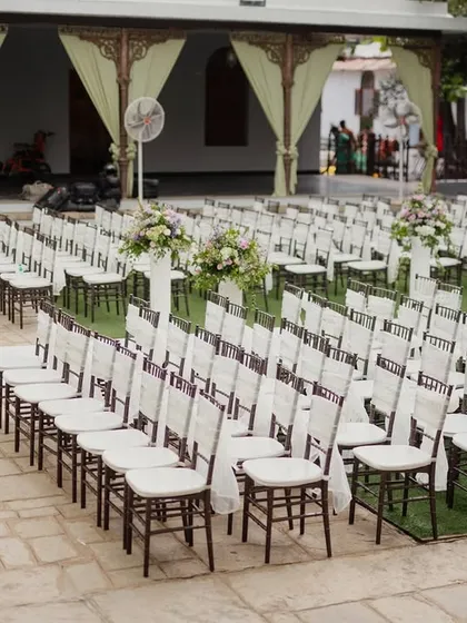 Guest seating arranged for a ceremony, with simple white bows on the chairs.