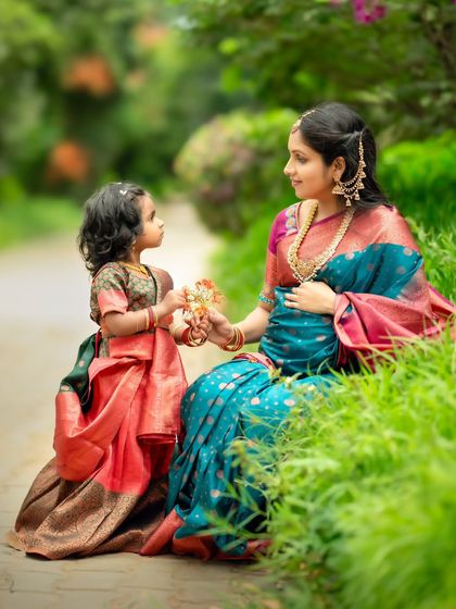 A heartwarming moment between a mother and daughter, as the little one offers her mom a flower.
