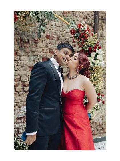 A sweet kiss on the cheek after the ring exchange. A simple, happy moment from their intimate engagement celebration.