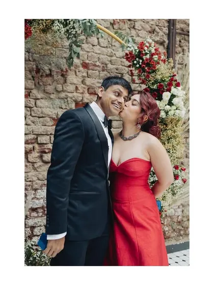 A sweet kiss on the cheek after the ring exchange. A simple, happy moment from their intimate engagement celebration.