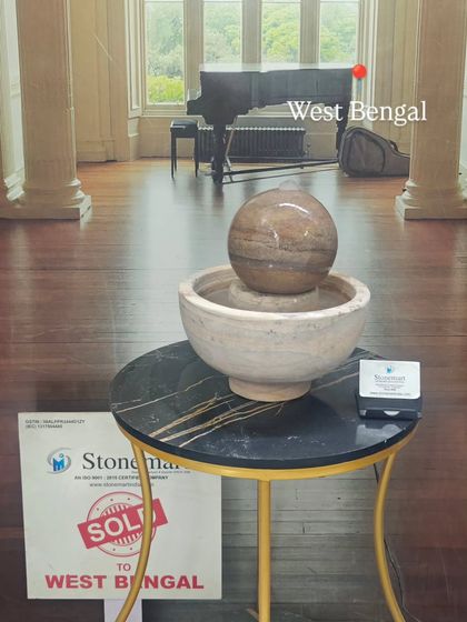 The Rainbow Sandstone tabletop fountain, sold to a client in West Bengal, is displayed on a modern side table.